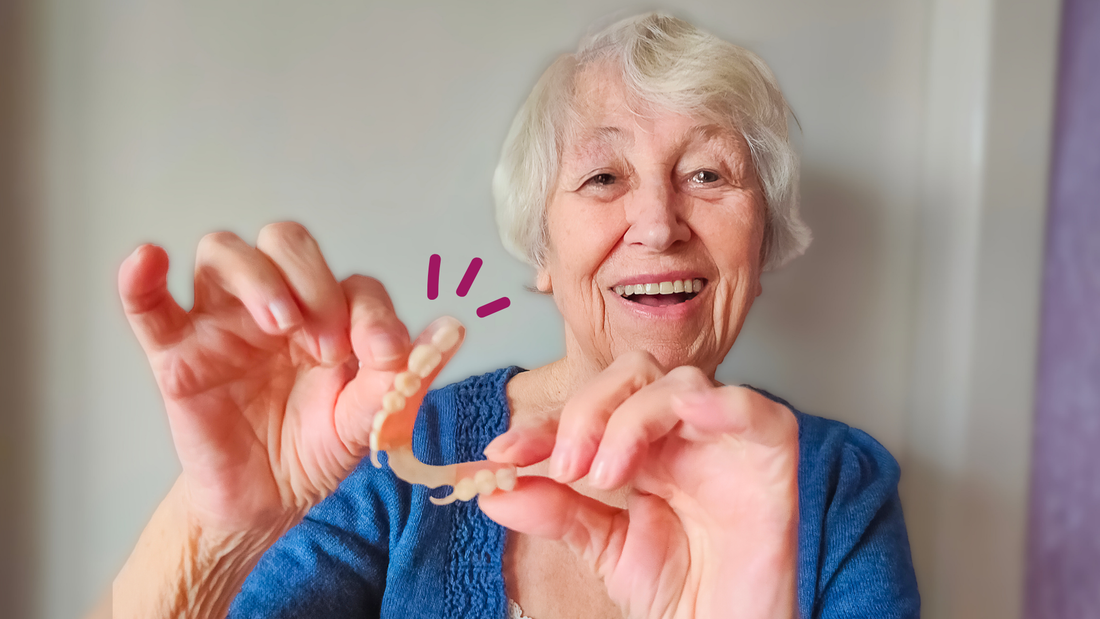 Older woman holding denture arches