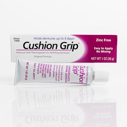 Cushion Grip denture adhesive packaging on a white background