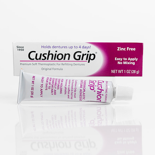 Cushion Grip denture adhesive packaging on a white background