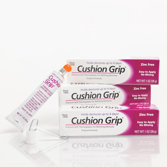 Cushion Grip denture adhesive packaging on a white background