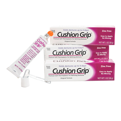 Cushion Grip denture adhesive packaging on a white background