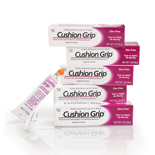 Cushion Grip denture adhesive packaging on a white background